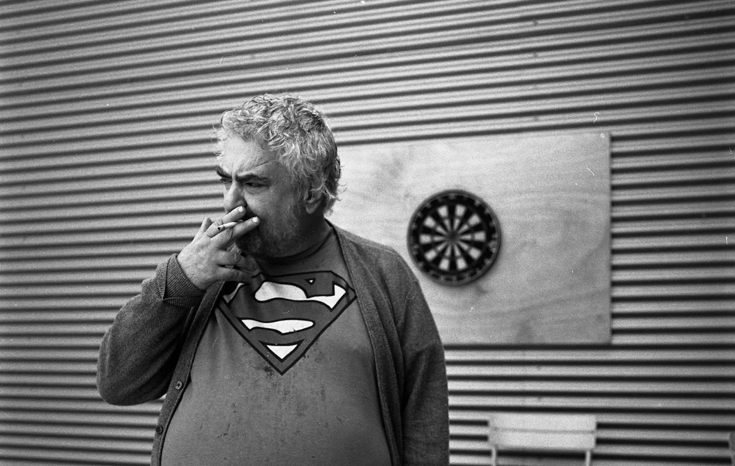 Daniel Johnston smoking while wearing Superman t-shirt